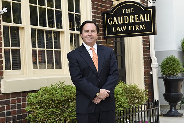 Attorney Kenneth D. L. Gaudreau standing in welcome in front of his law firm